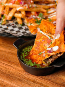 Frida's Birria Pizza slice dlipping